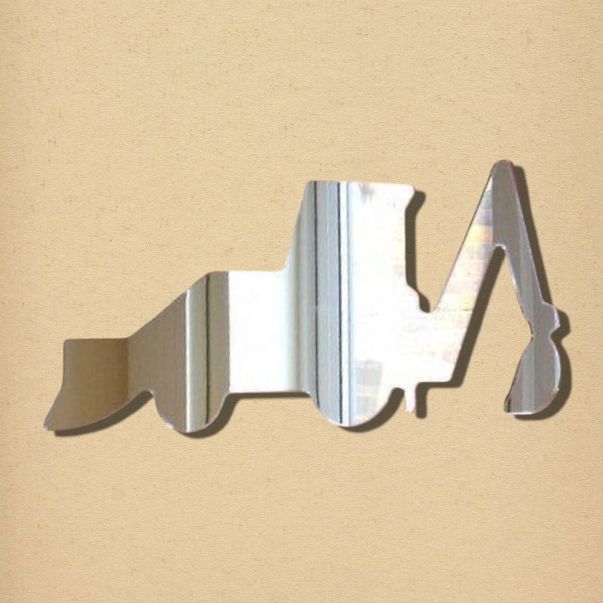 Digger-shaped acrylic mirror against a textured beige background.