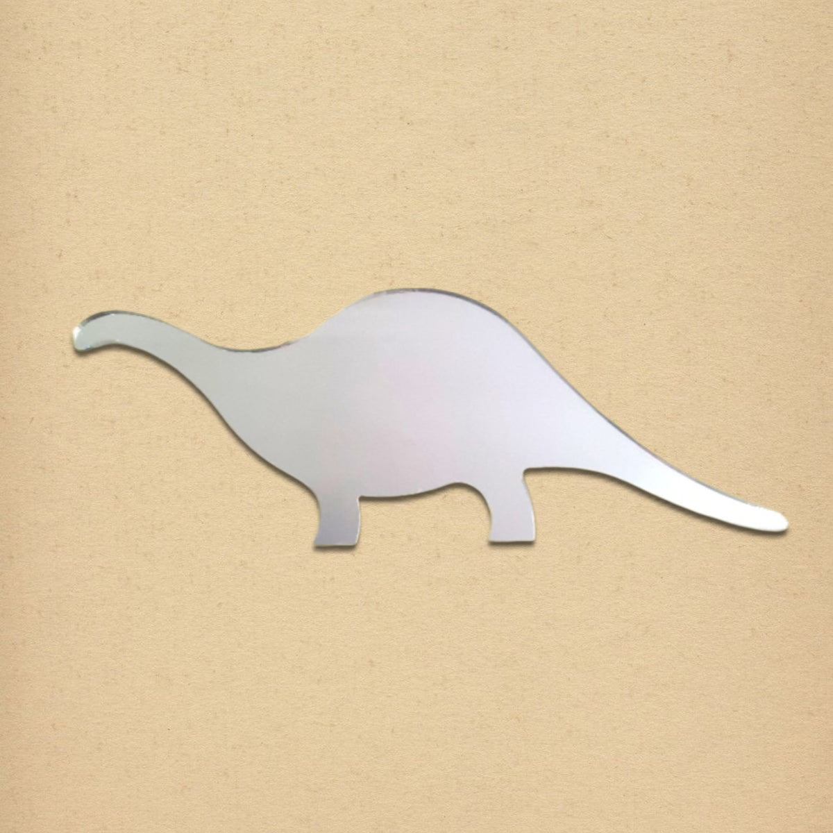 A silver brontosaurus-shaped mirror is displayed against a plain tan background.