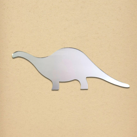 A silver brontosaurus-shaped mirror is displayed against a plain tan background.