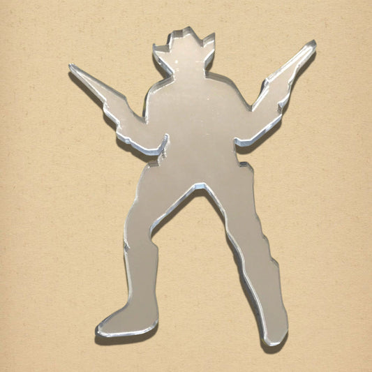 Cowboy-shaped mirror in a cowboy hat holding two guns against a tan background.