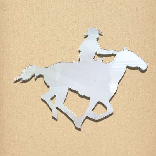 Cowboy on horse-shaped mirror with silver reflective surface against a tan background.