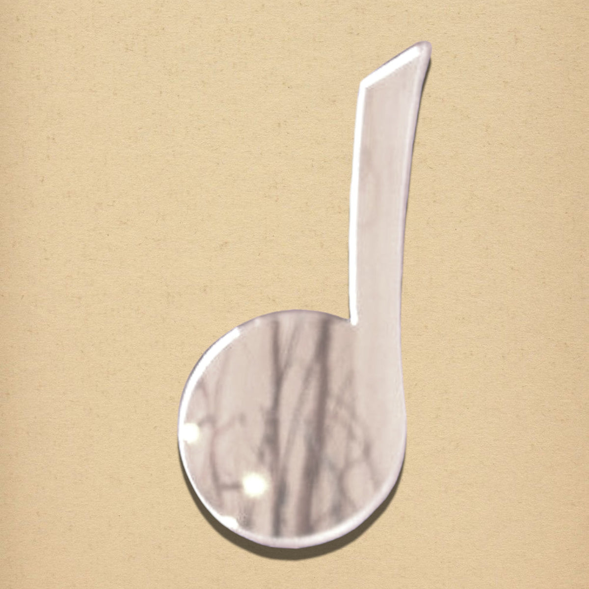 Crotchet mirror shaped like a musical note on a textured beige background.