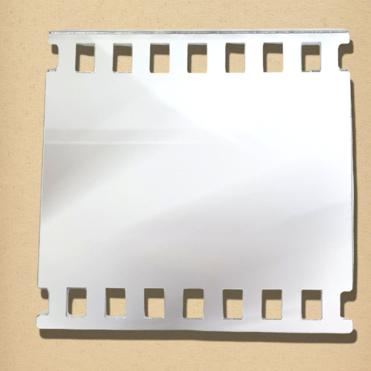 Silver mirror shaped like a square vintage camera film strip with sprocket holes along the top and bottom edges.