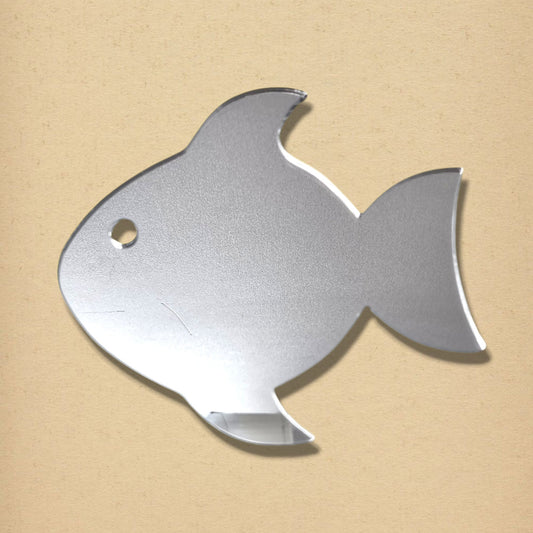 Fish-shaped silver mirror with a small circular hole for an eye, centered on a neutral beige background.