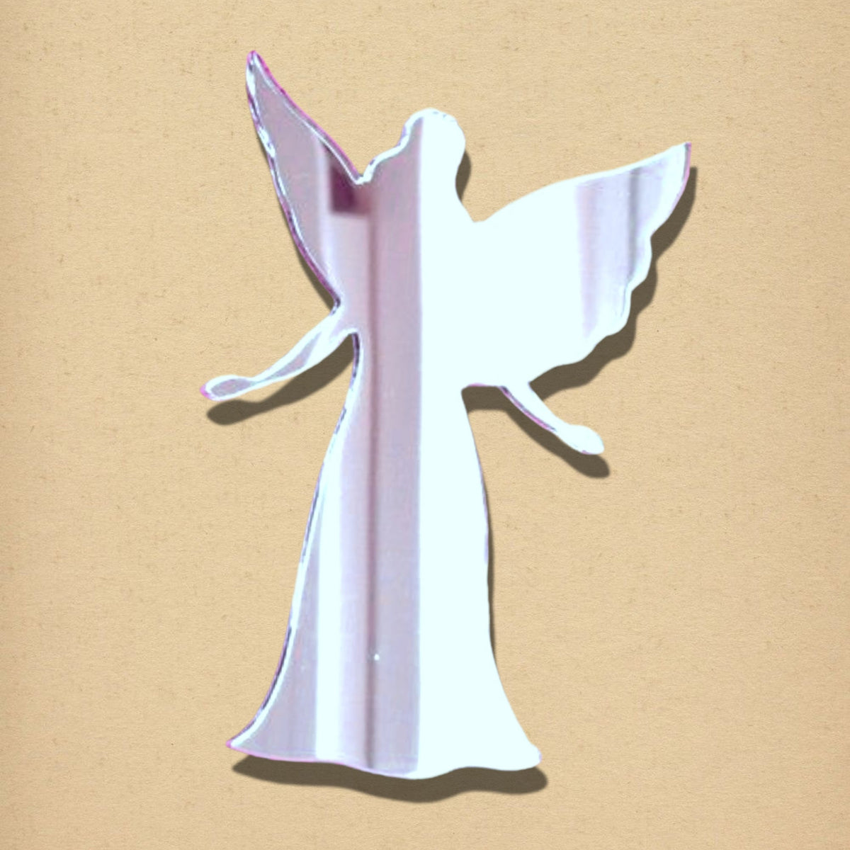 Fairy-shaped reflective mirror with wings, against a beige background.