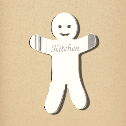 Reflective gingerbread man mirror with engraved facial features and the word Kitchen on the chest.