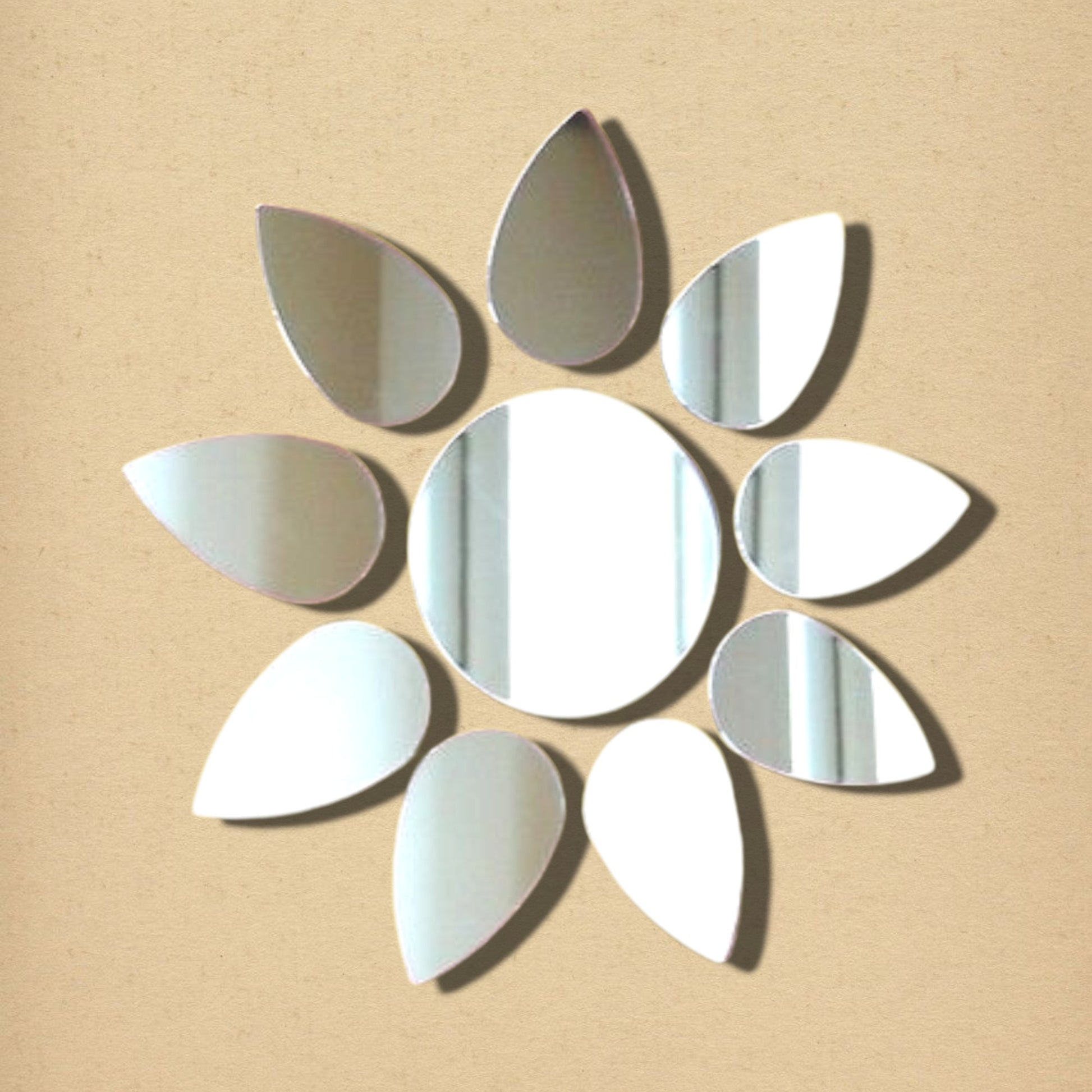 Flower-shaped acrylic mirror featuring a central circle surrounded by ten teardrop-shaped mirror petals on a tan background.