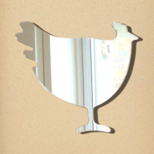 Hen-shaped reflective mirror on a tan background.