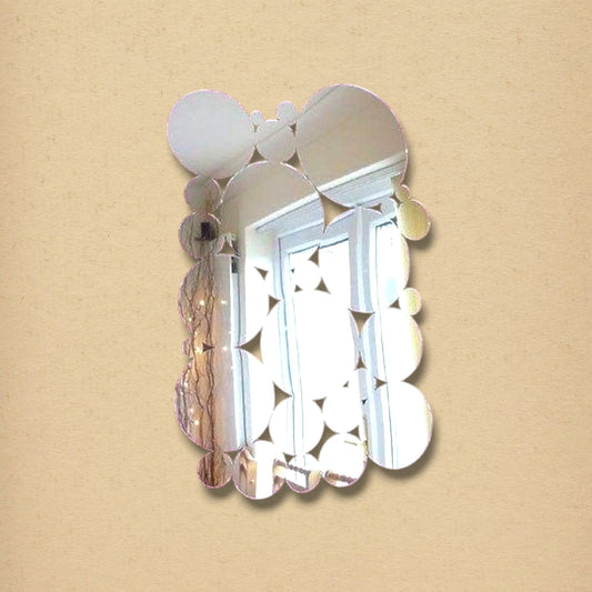 A vertical wall mirror composed of overlapping circular glass panels of varying sizes.