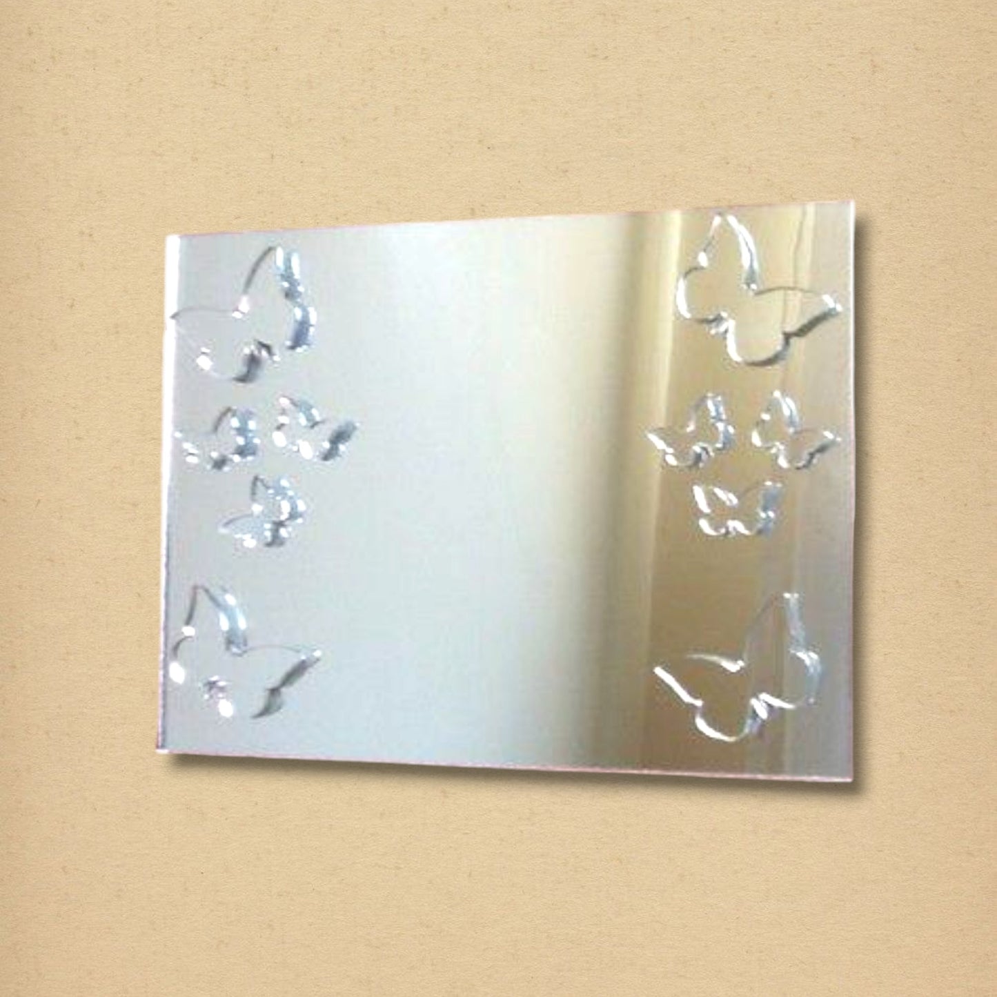 Rectangular silver mirror decorated with engraved butterflies along the left and right edges.