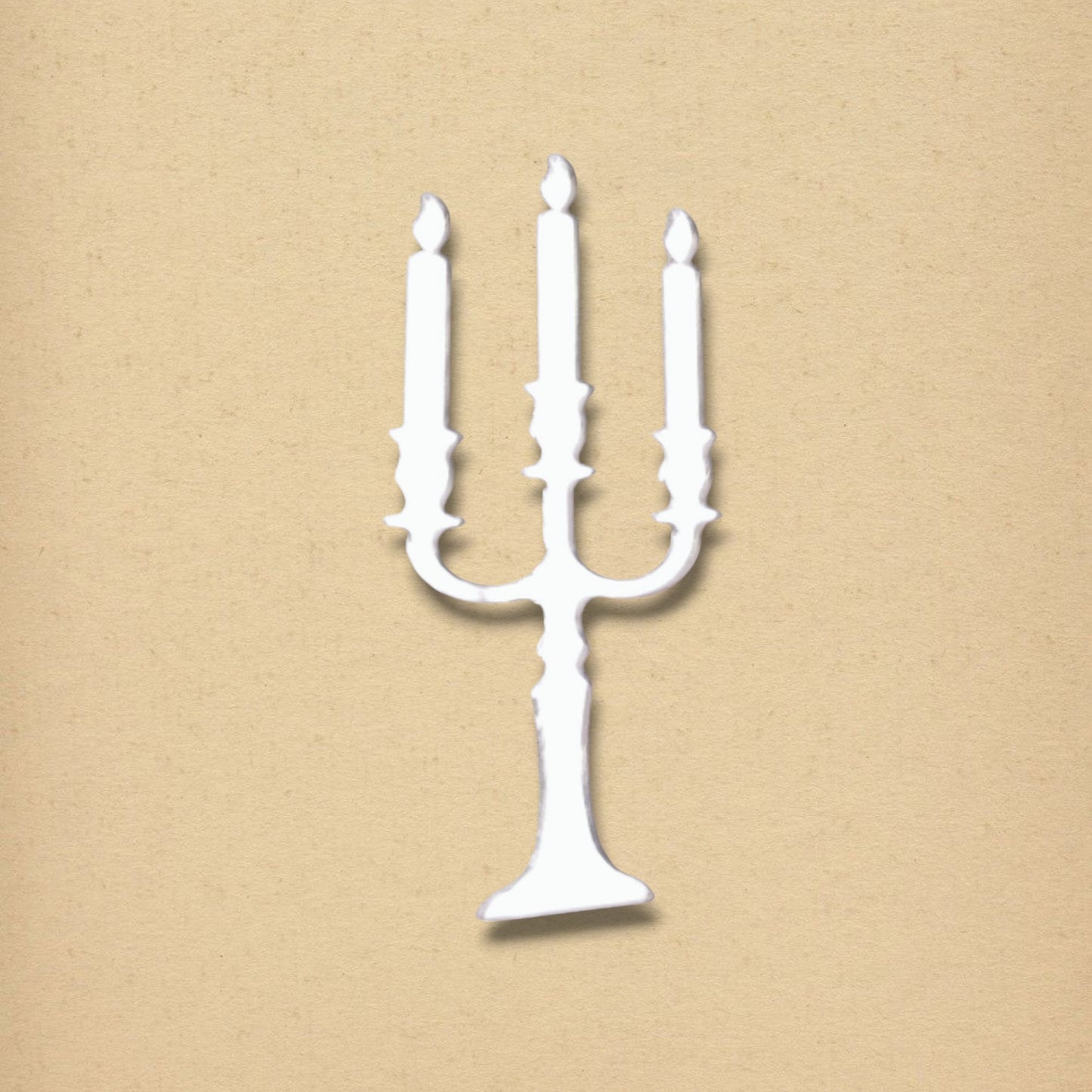 White candelabra-shaped mirror on a textured beige background.