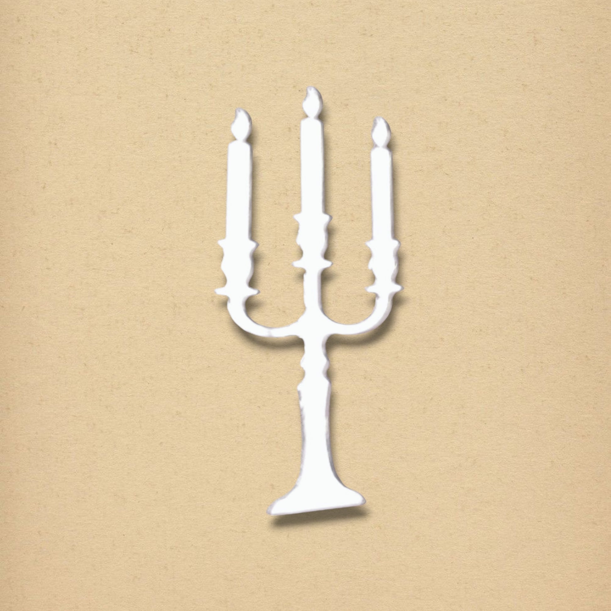 White candelabra-shaped mirror on a textured beige background.
