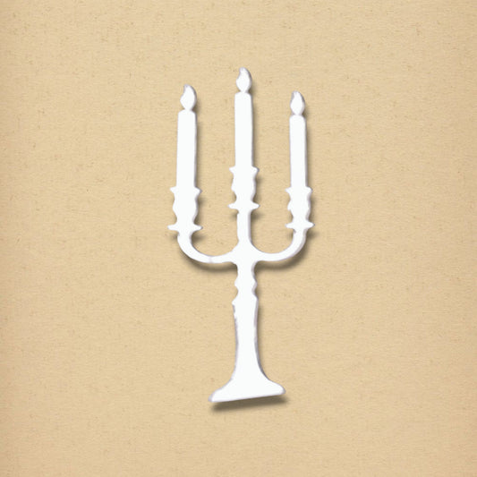 White candelabra-shaped mirror on a textured beige background.