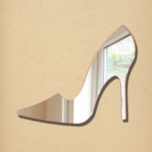 High heel shoe-shaped mirror with a rose-colored border, mounted on a tan textured background.
