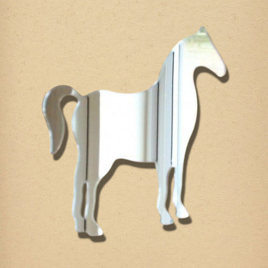 Silver horse-shaped mirror against a textured tan background.