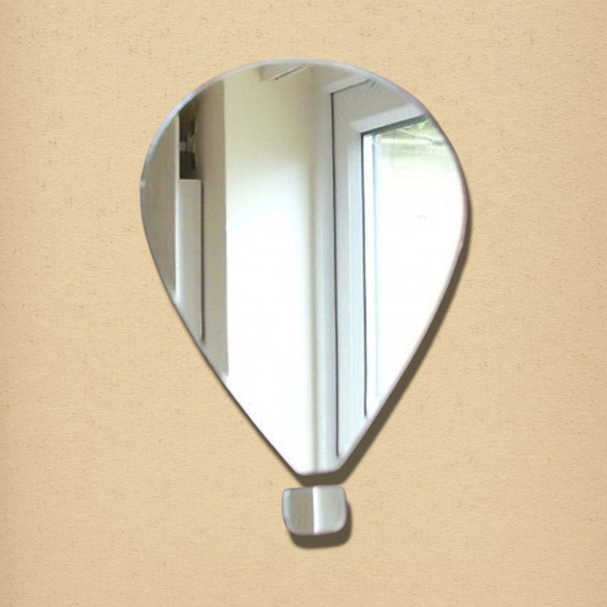Hot air balloon-shaped wall mirror with a small, separate rectangular piece below representing the basket.