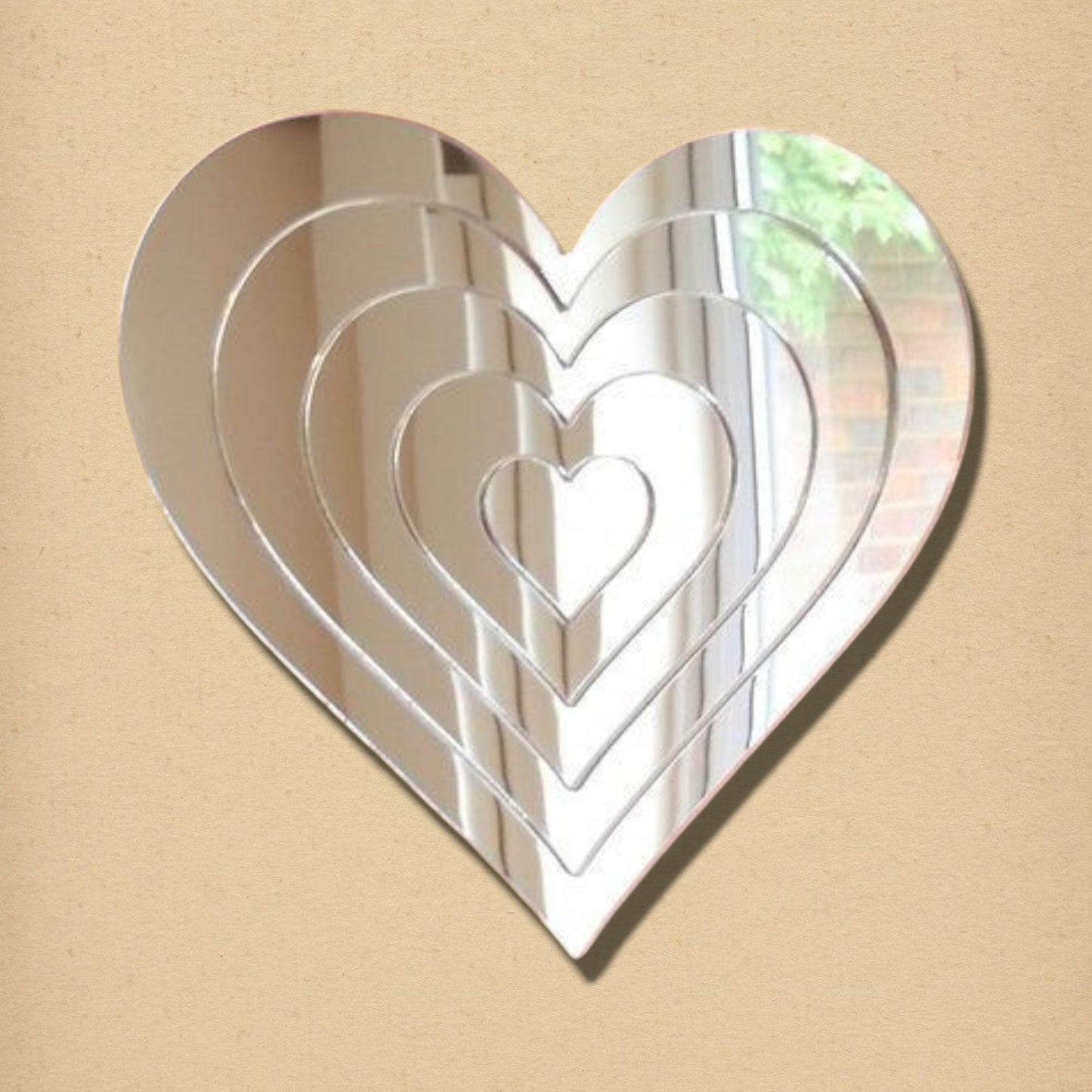 Heart-shaped silver mirror featuring a nested, concentric infinity heart design.