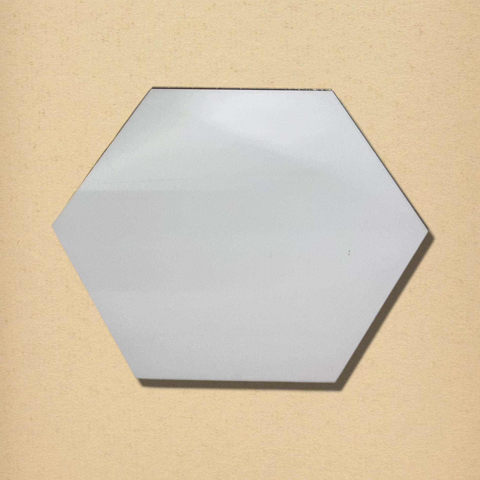 A single hexagonal glass mirror against a textured beige background.