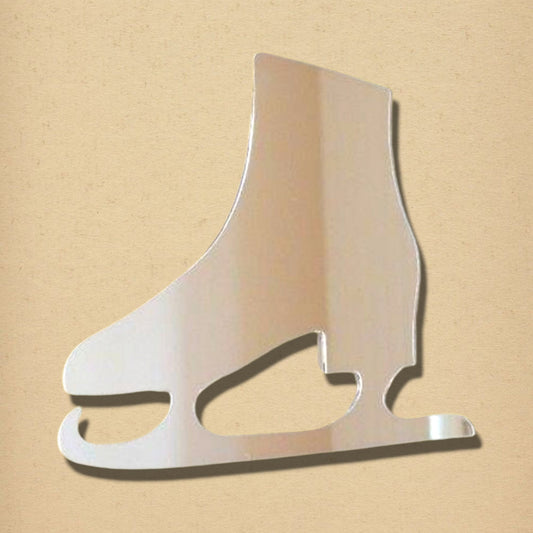 Ice skate-shaped mirror with a reflective silver surface against a neutral beige background.