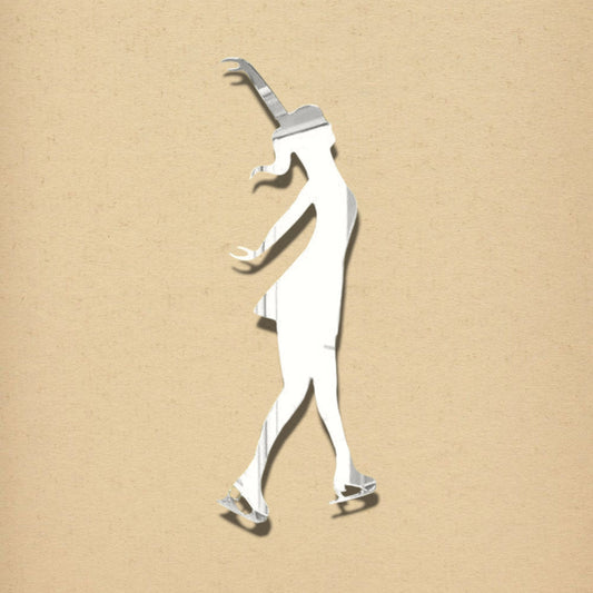 An ice skater shaped silver mirror against a beige textured background.