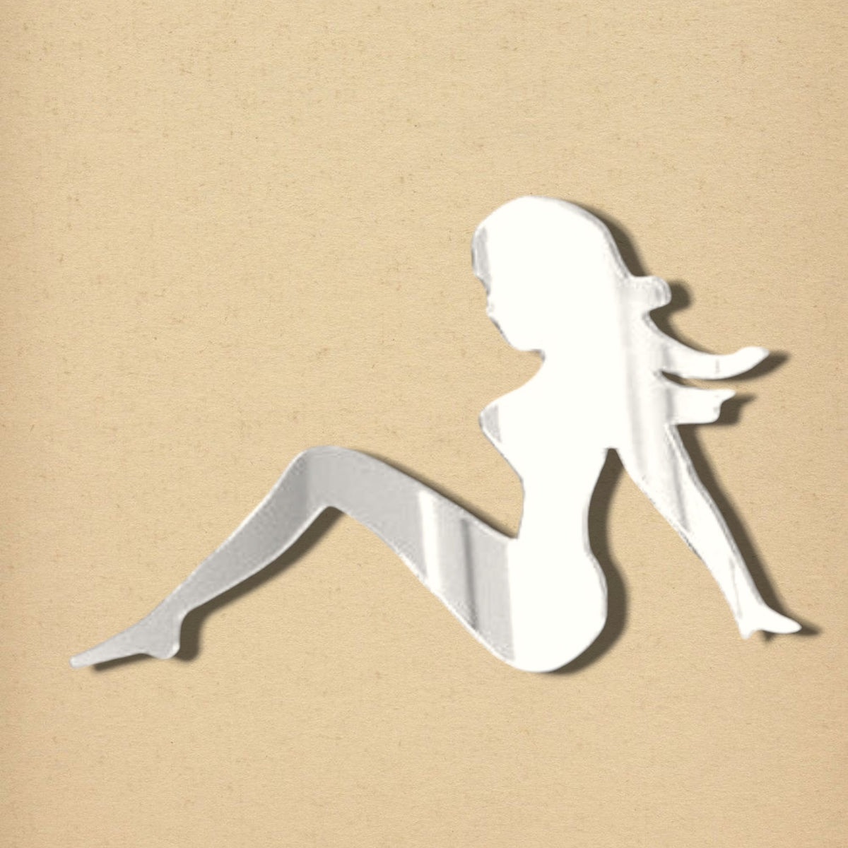 Silvery acrylic mirror in the silhouette shape of a reclining woman with long hair.