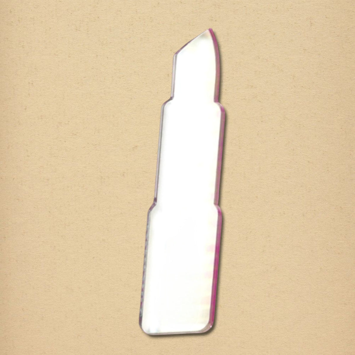 Lipstick-shaped mirror with a pink border on a textured tan background.