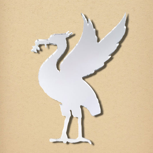 Liver bird-shaped acrylic mirror in reflective silver, shown against a textured beige background.