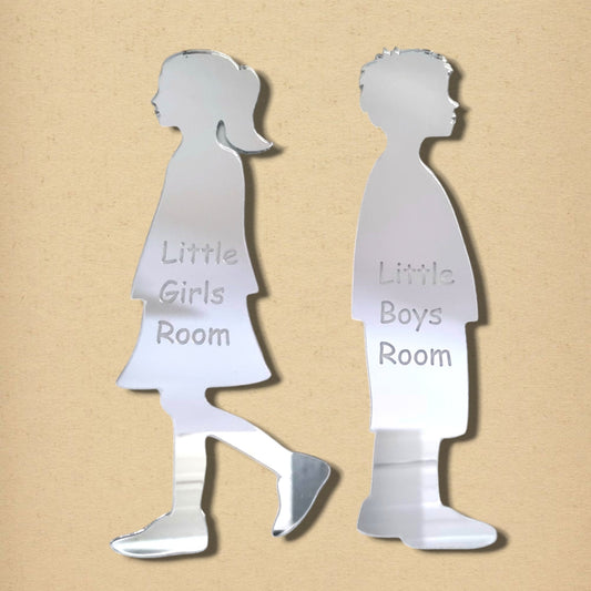 Silver acrylic mirrors shaped like a girl and boy, engraved with “Little Girls Room” and “Little Boys Room.”