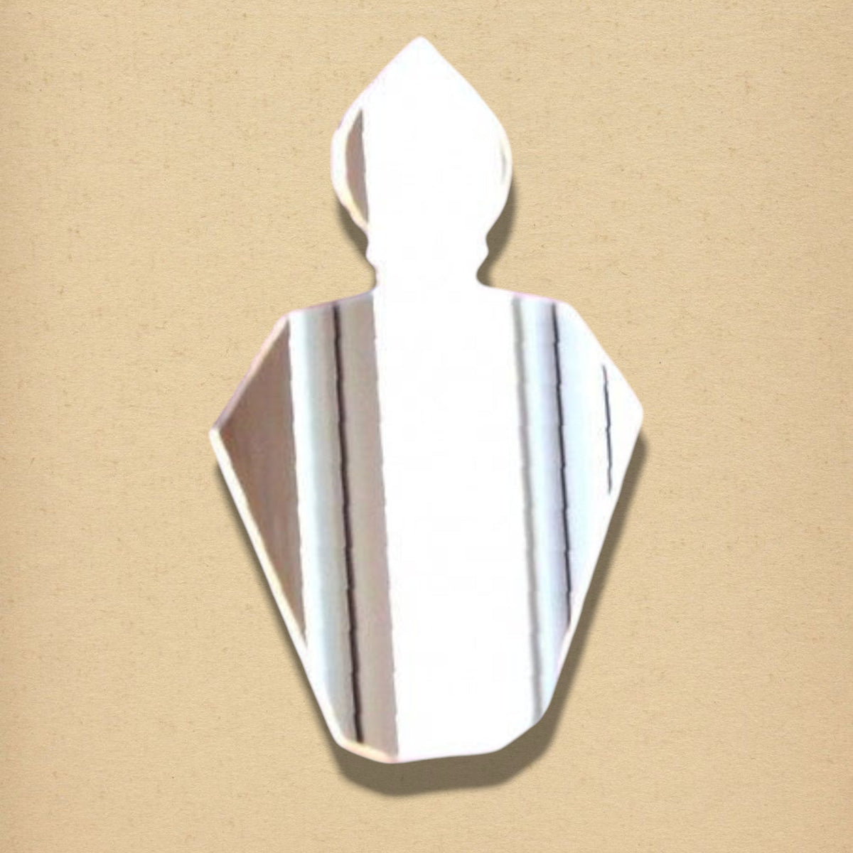 A silver perfume bottle-shaped mirror against a neutral beige background.