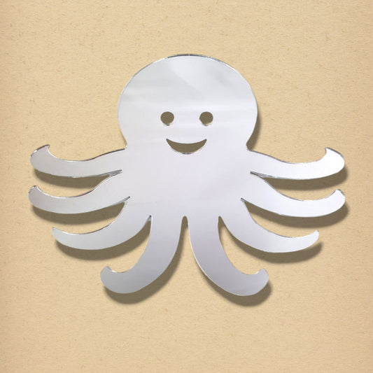Silver octopus-shaped mirror with a smiling face cut-out, against a tan background.