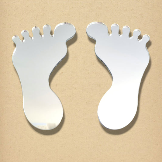 A pair of foot-shaped silver mirrors on a neutral background.