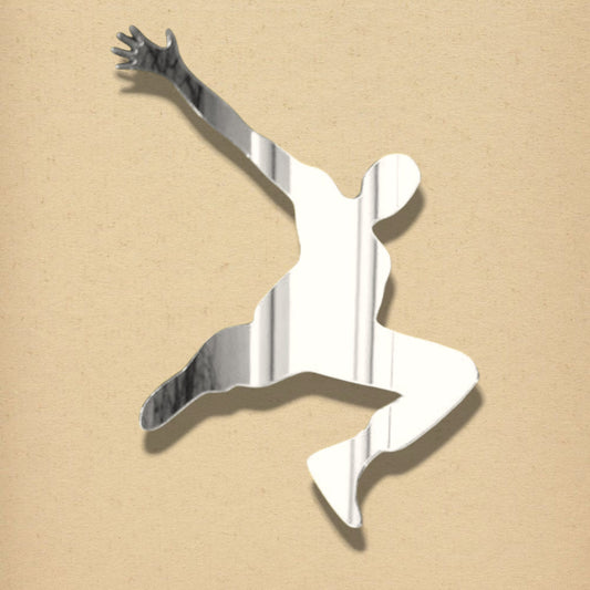A silver mirrored wall sticker shaped like a person doing a parkour jump.