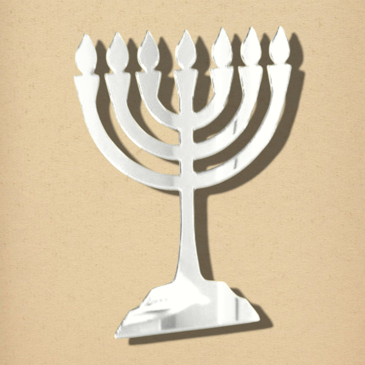 Menorah-shaped silver acrylic mirror on a tan textured background.