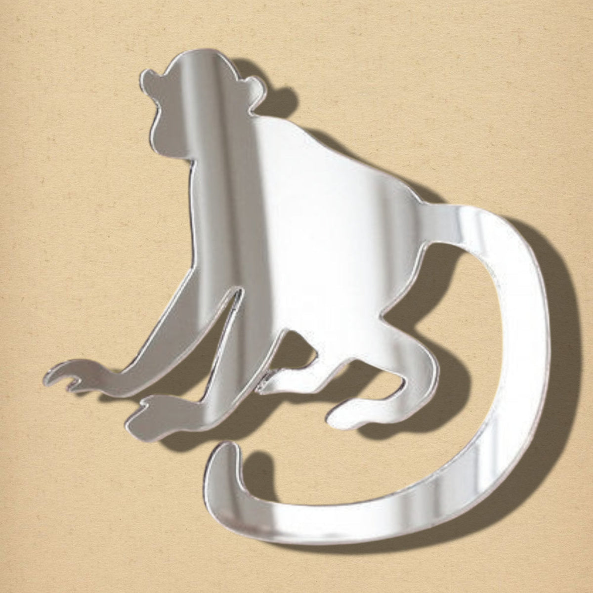 Silver mirror shaped like a monkey with a curved tail.