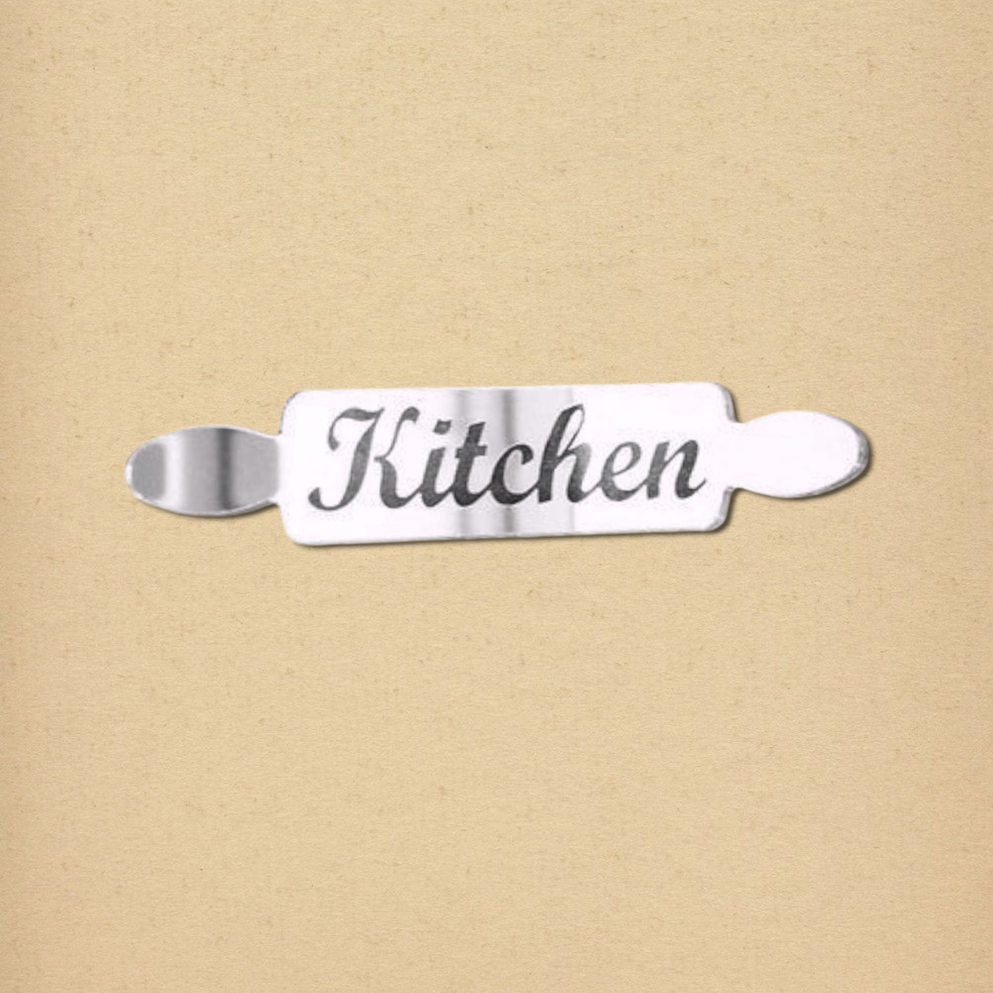 Silver rolling pin-shaped mirror door sign with the word "Kitchen" in cursive.