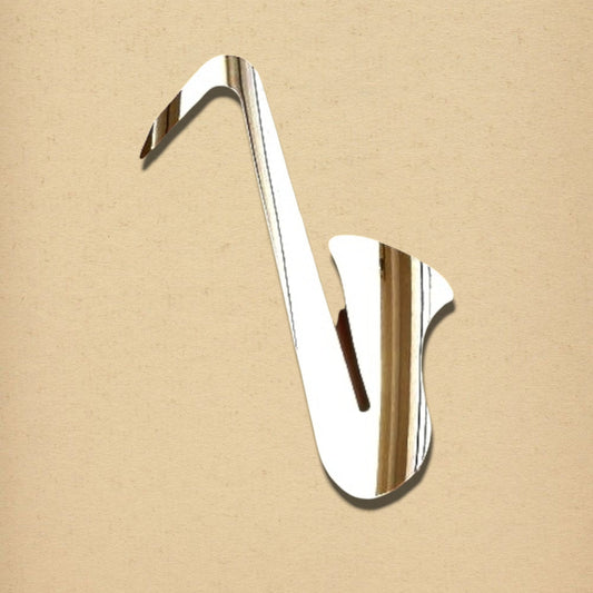 Silver saxophone-shaped mirror on a textured beige background.