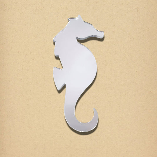 A silver seahorse-shaped mirror against a beige background.