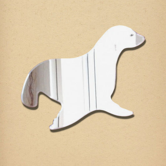A sea lion-shaped mirror on a textured tan background.