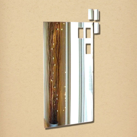 A rectangular wall mirror with cutout rectangular pieces arranged near the top right corner.