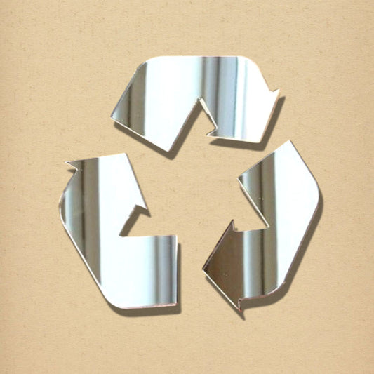 Recycle symbol acrylic mirror sign on a beige background.