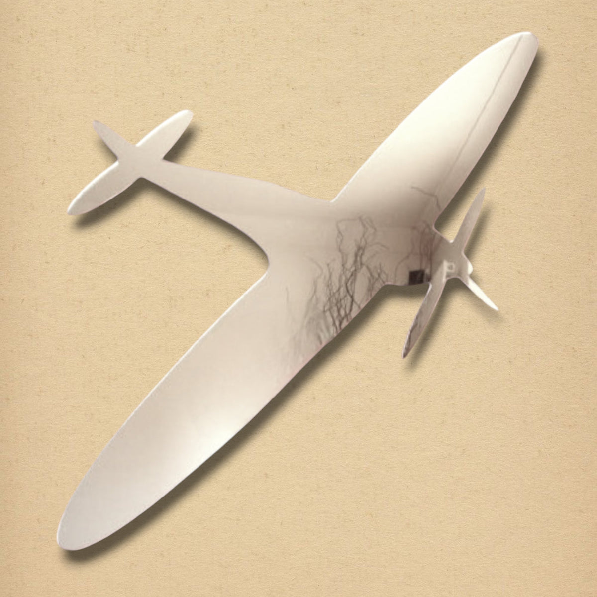 Spitfire-shaped silver mirror with propeller details on a tan background.