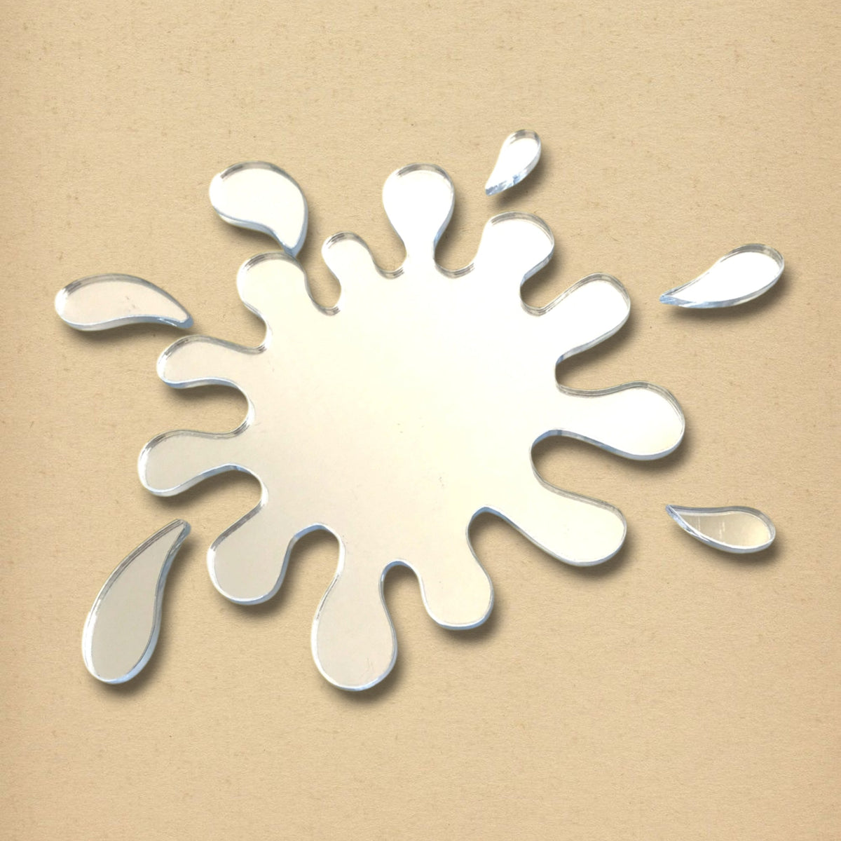 Splash Mirror shaped like a liquid splash with detached droplet pieces against a plain background.