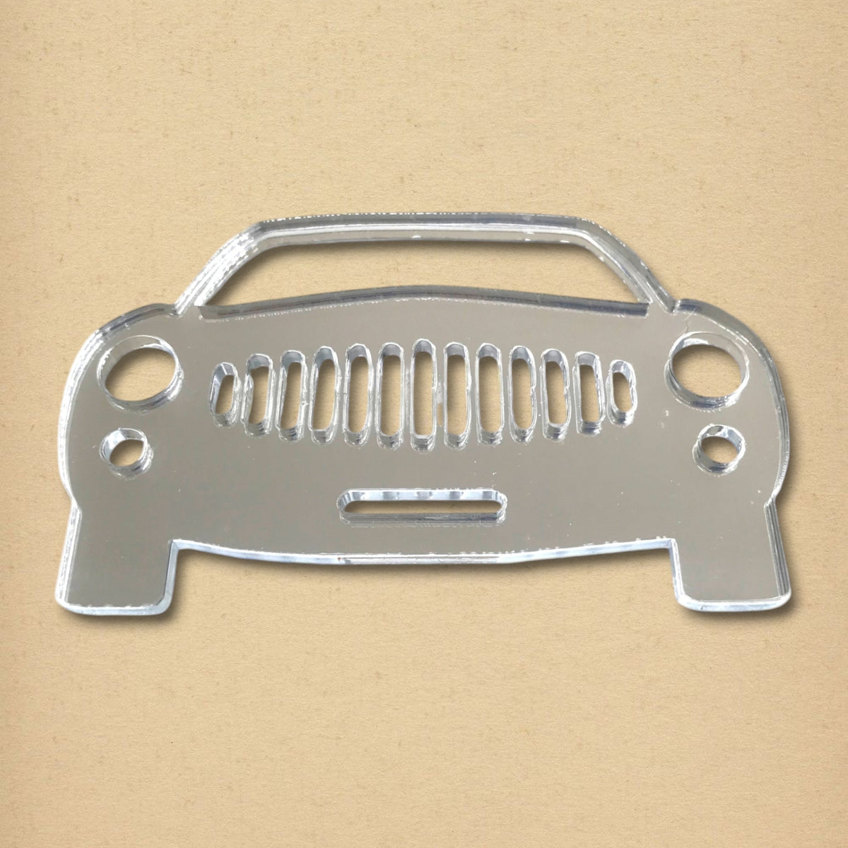 A sports car shaped reflective acrylic mirror with cutout grill and headlight details.
