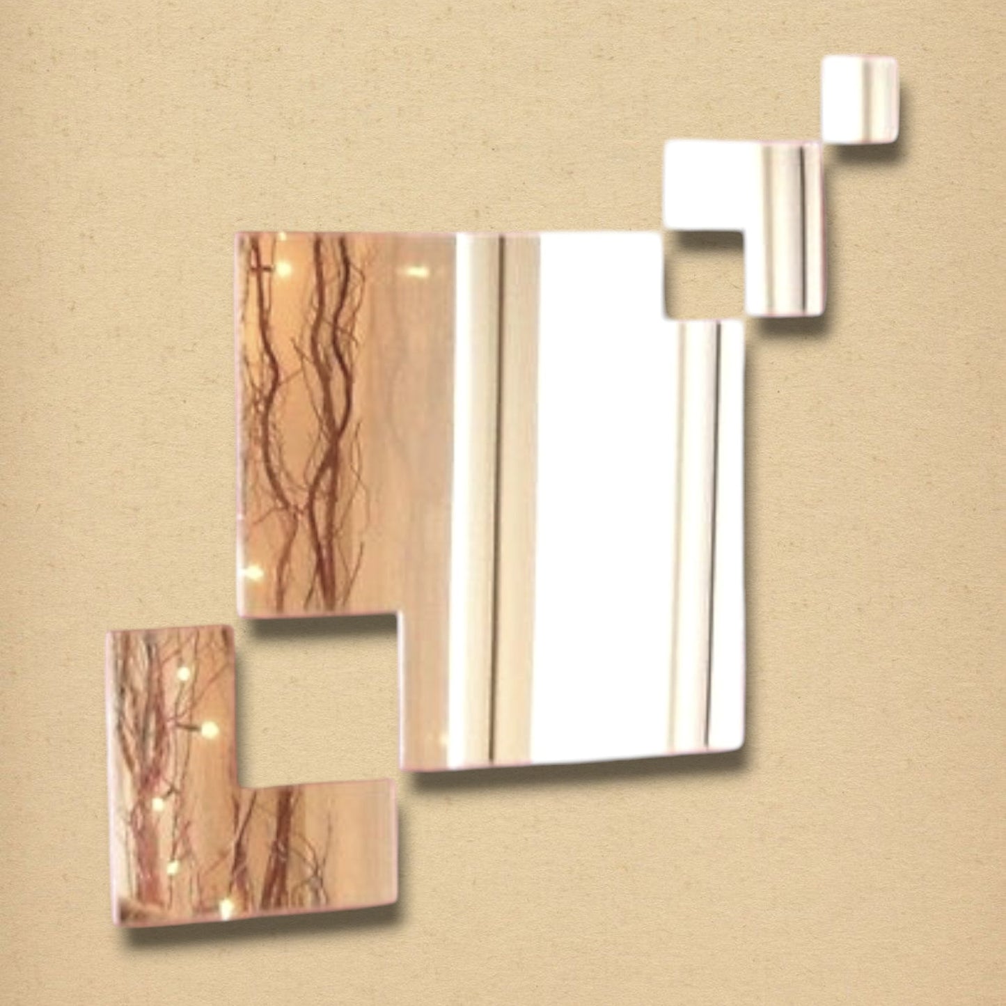 A wall mirror composed of four connected square glass pieces of varying sizes on a beige background.