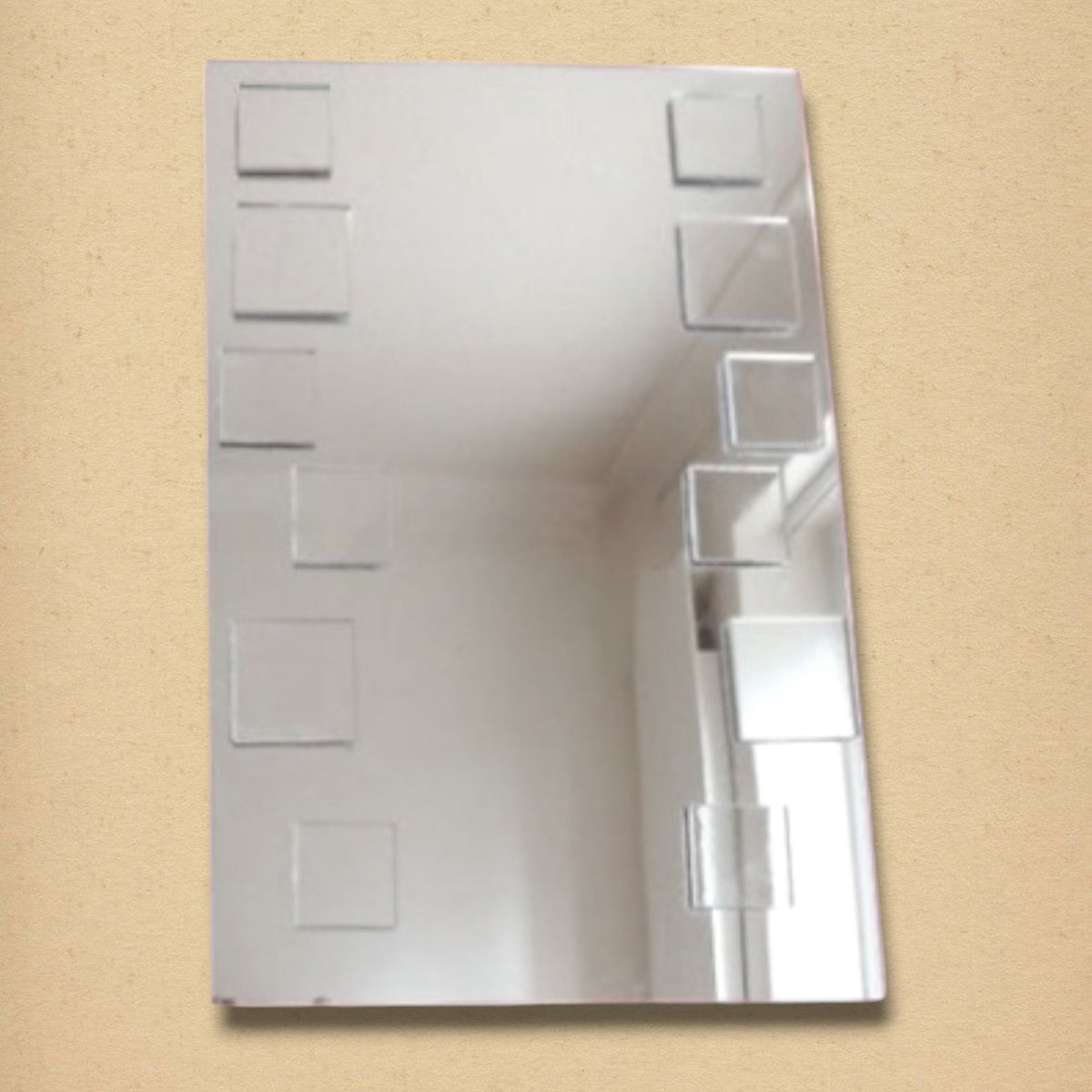 A rectangular mirror decorated with smaller mirrored squares arranged along both sides.