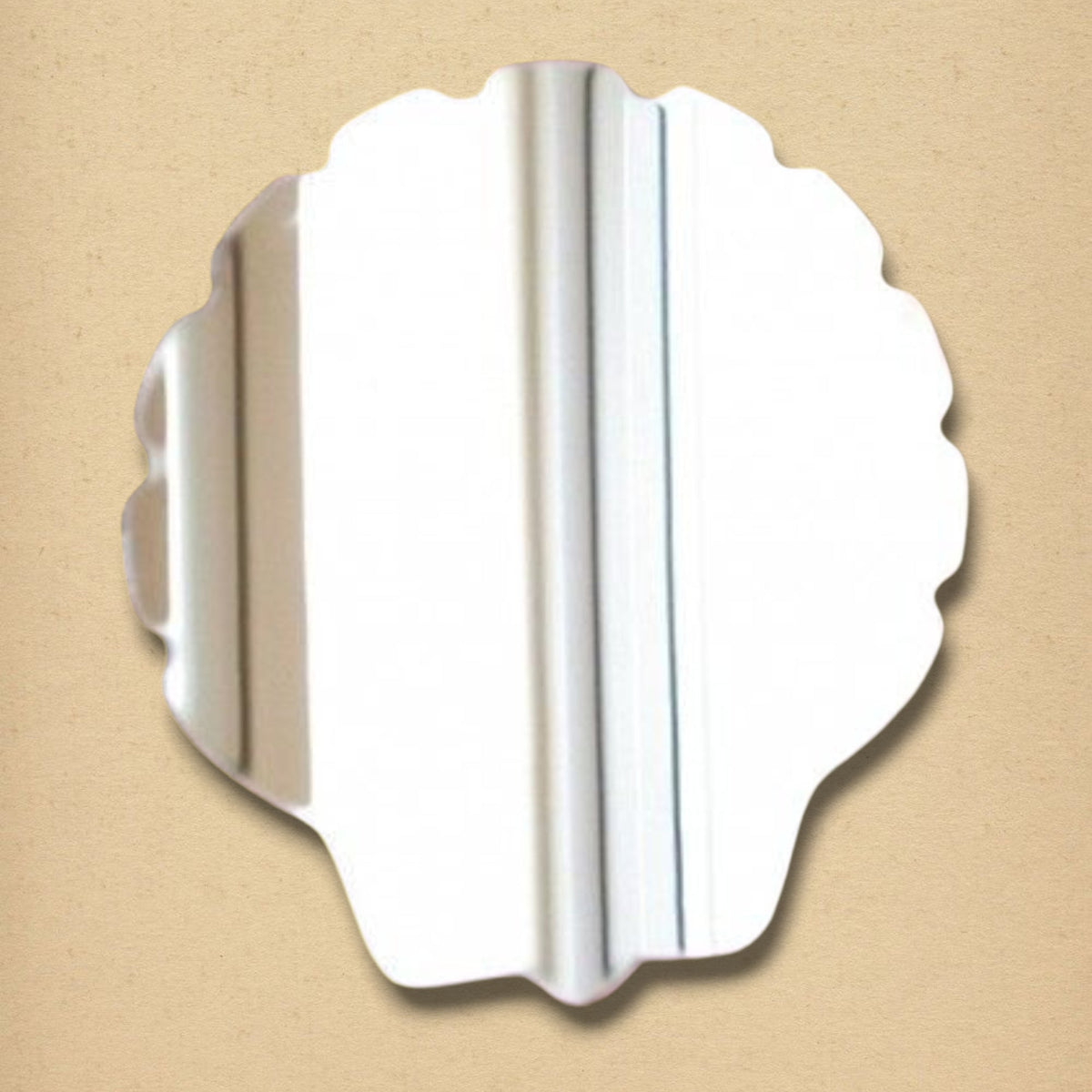 Shell-shaped mirror with a scalloped edge on a tan background.