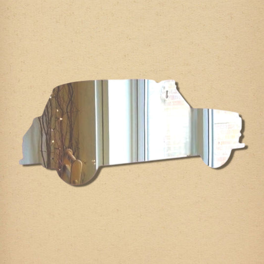 Taxi cab-shaped silver reflective mirror on a tan background.