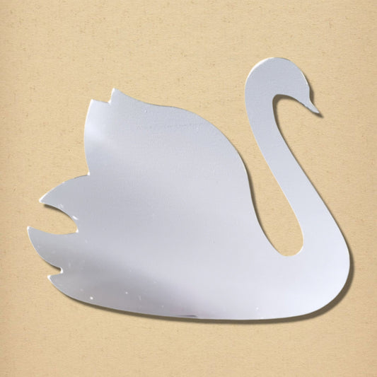 A silver swan-shaped mirror against a tan textured background.