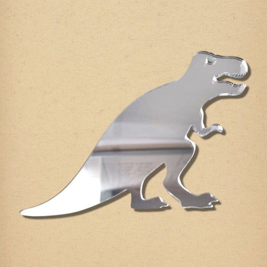 Silver acrylic T-Rex dinosaur-shaped mirror against a tan background.