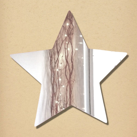 Five-pointed star-shaped mirror reflecting a string of lights and branches against a beige background.